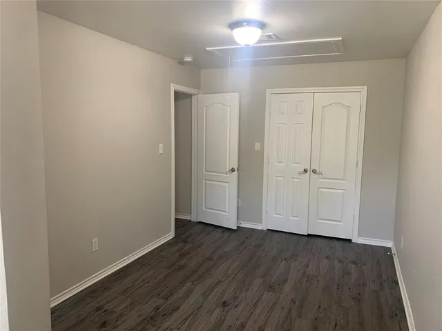 an empty room with wooden floor