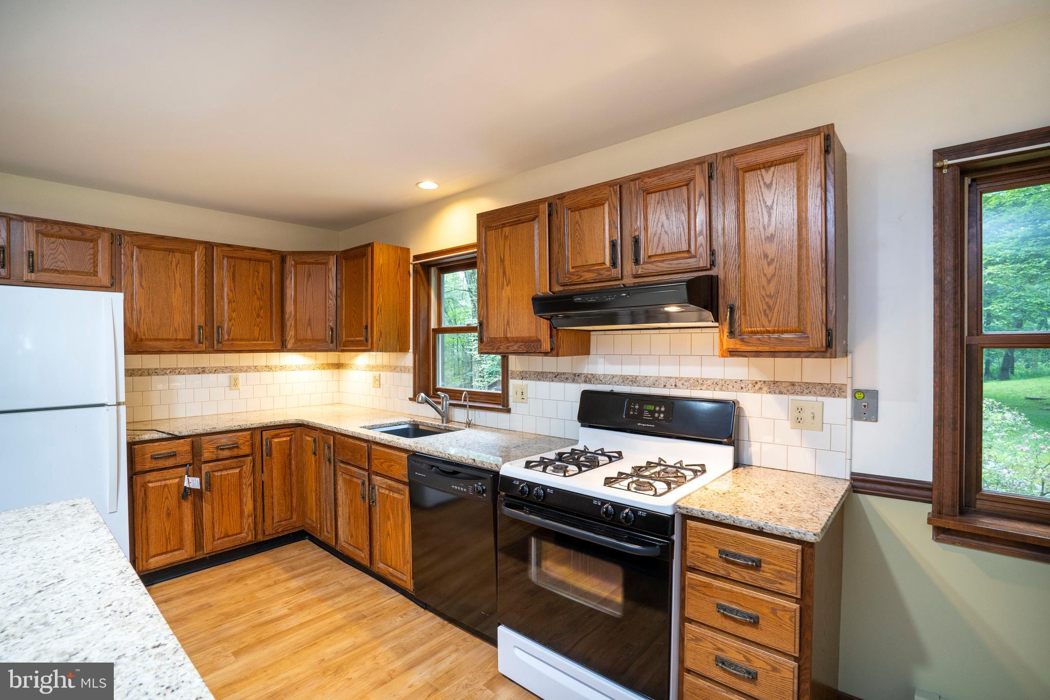 1040 Radio Club Road Montoursville, PA 17754 - Photo 14 of 58 a kitchen with granite countertop a sink stove and refrigerator