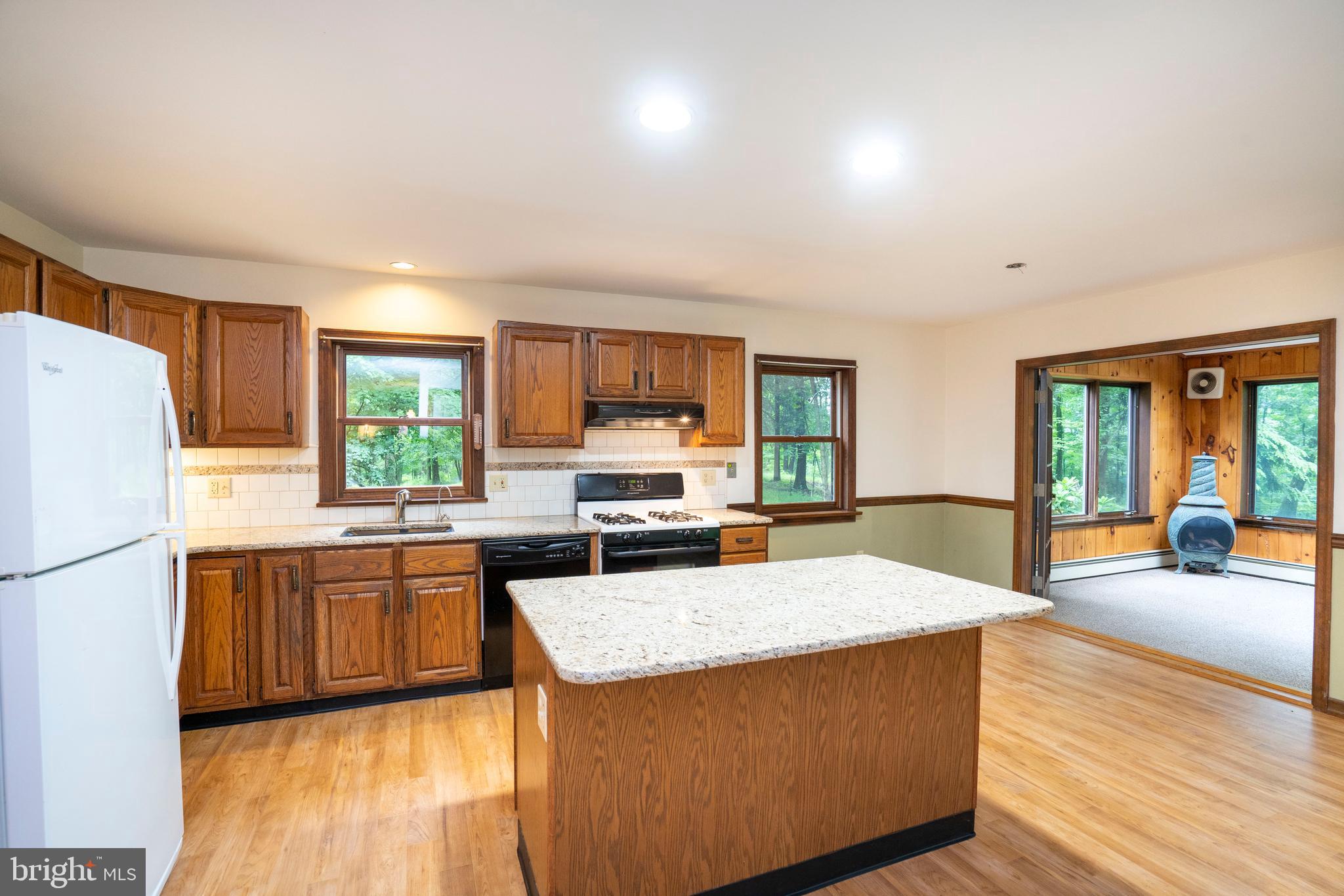 1040 Radio Club Road Montoursville, PA 17754 - Photo 2 of 58 a kitchen with stainless steel appliances granite countertop a refrigerator a sink dishwasher a stove and a dining table with wooden floor