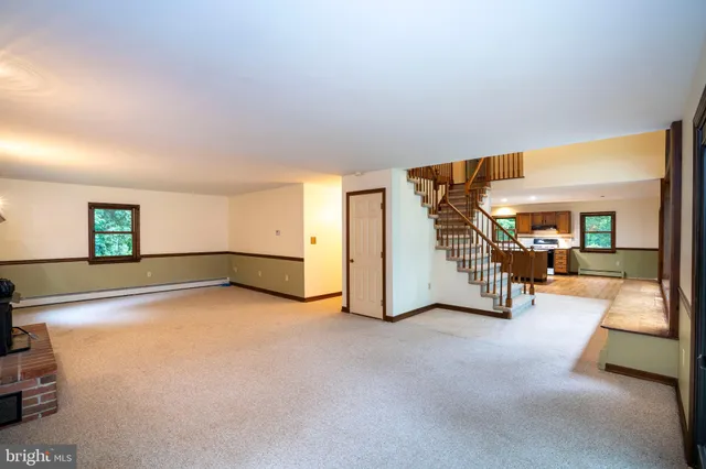a living room with fireplace and a wooden floor