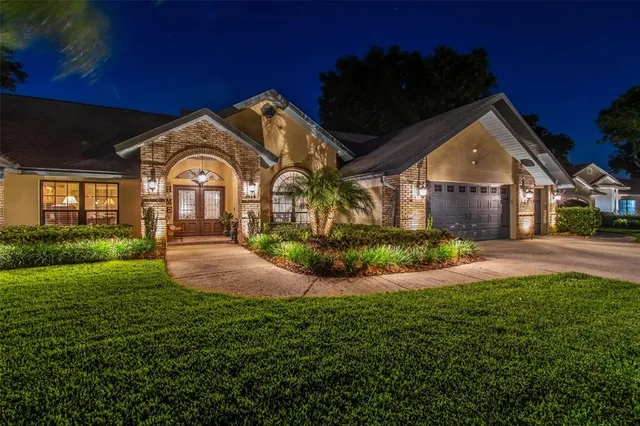 a view of a swimming pool with a table and chairs under an umbrella