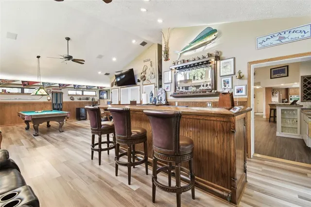 a aerial view of a house with swimming pool next to a yard