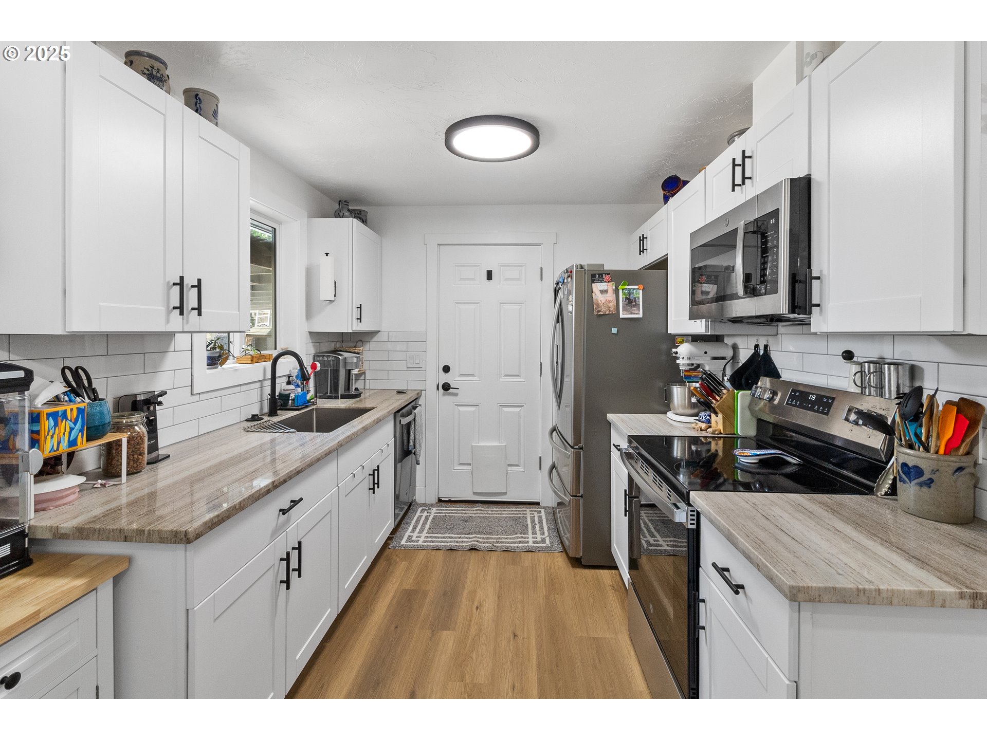 2681 D Street Springfield, OR 97477 - Photo 12 of 24 a kitchen with stainless steel appliances granite countertop a stove a sink a refrigerator and cabinets