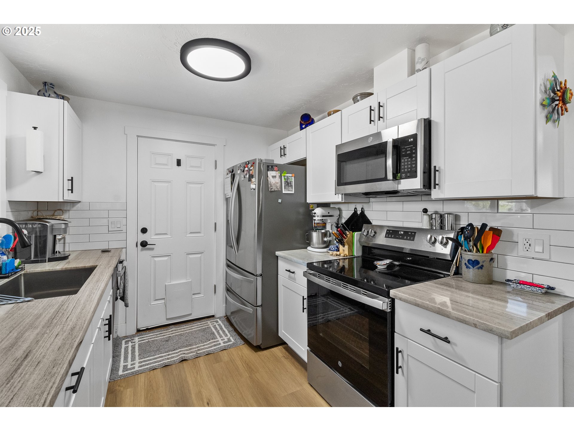 2681 D Street Springfield, OR 97477 - Photo 13 of 24 a kitchen with stainless steel appliances granite countertop a stove a sink and a refrigerator
