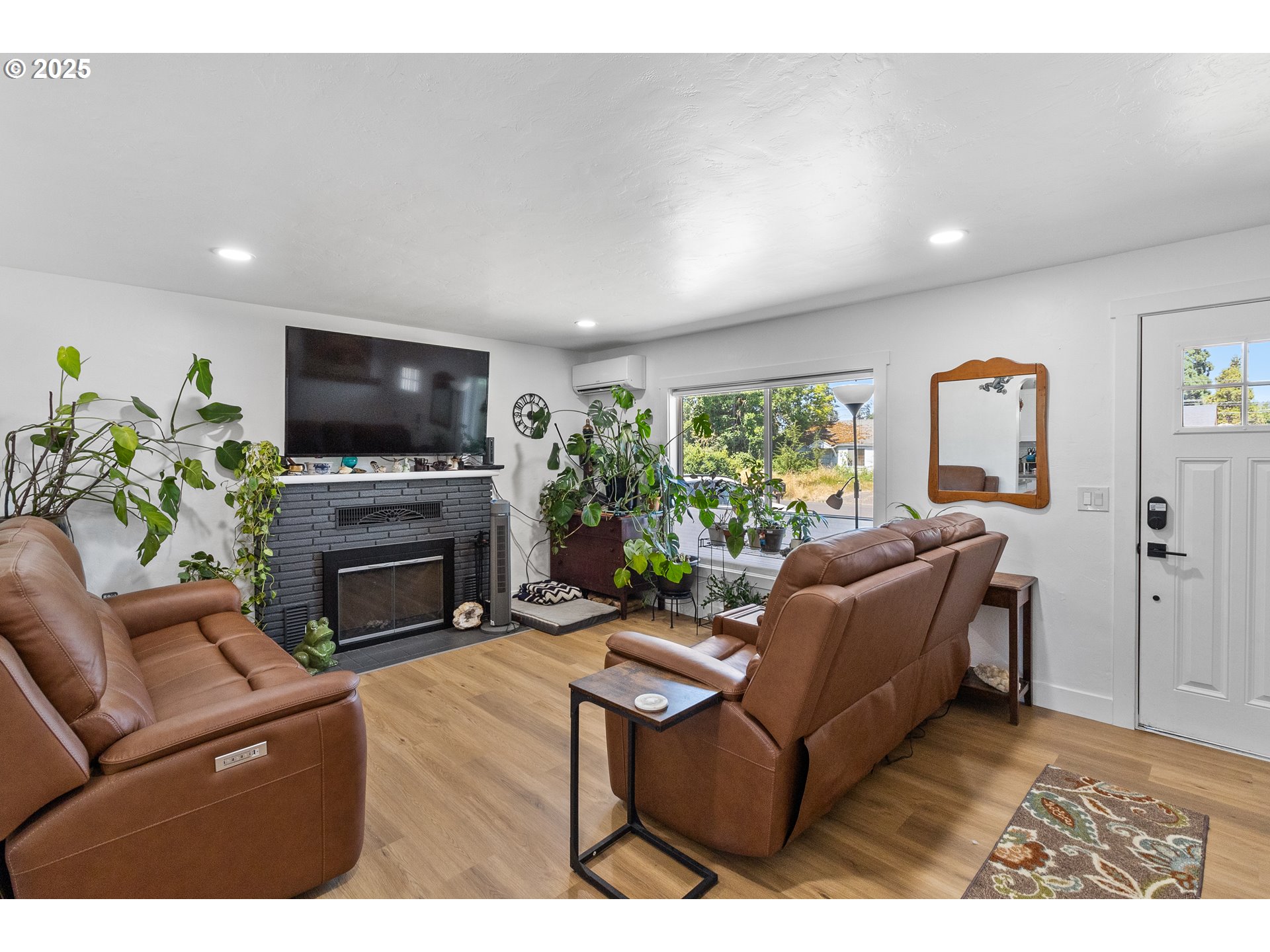 2681 D Street Springfield, OR 97477 - Photo 8 of 24 a living room with furniture a fireplace and a flat screen tv