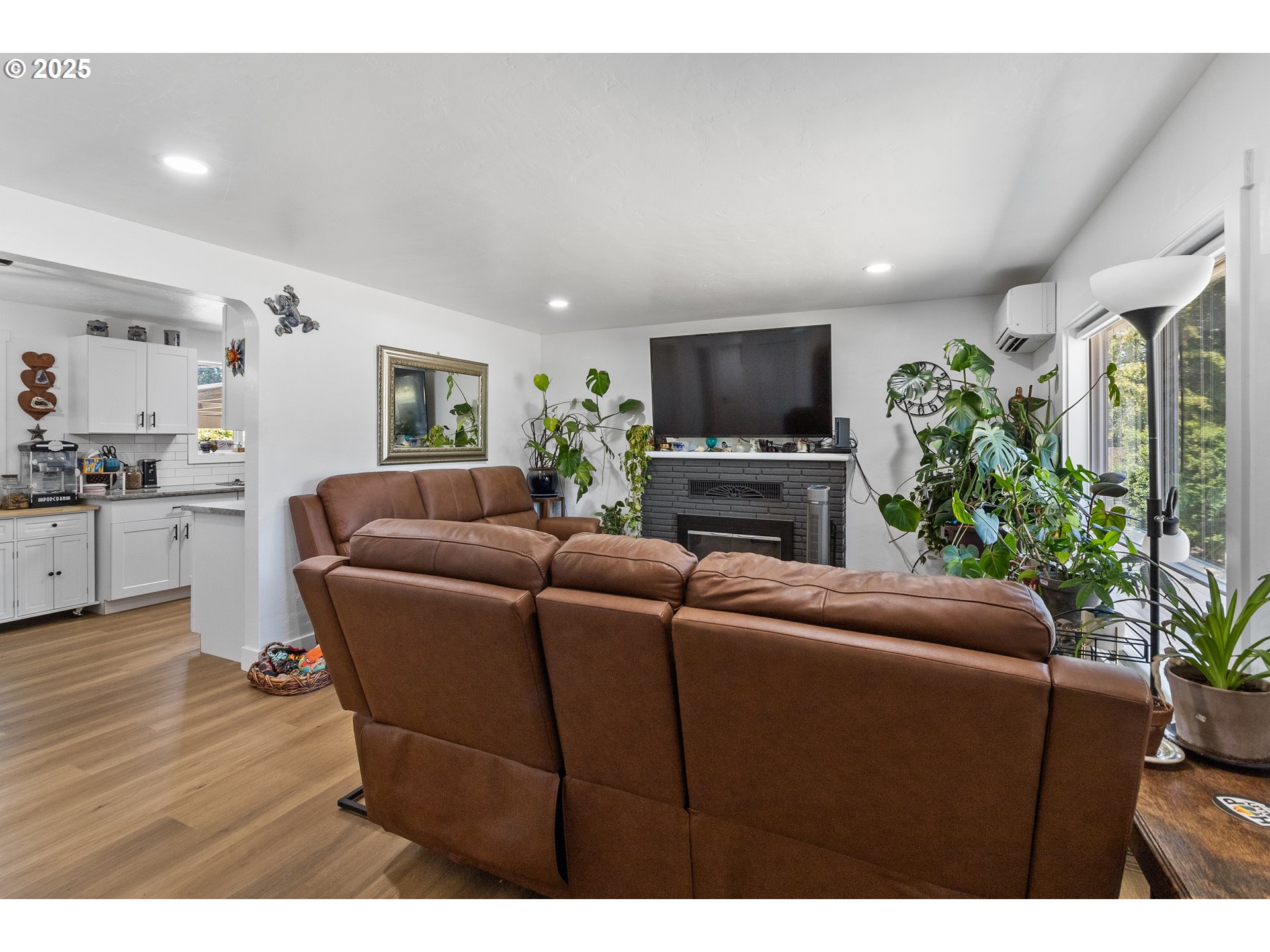 2681 D Street Springfield, OR 97477 - Photo 10 of 24 a living room with furniture a flat screen tv and a fireplace