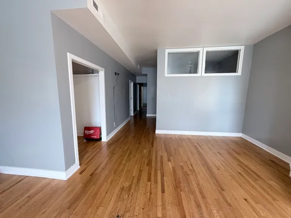 a view of a room with wooden floor and stairs