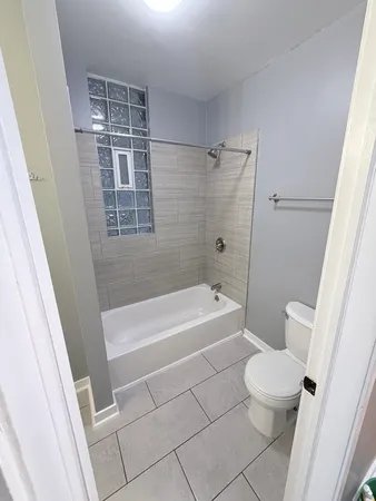 a bathroom with a bathtub a toilet a sink and a shower