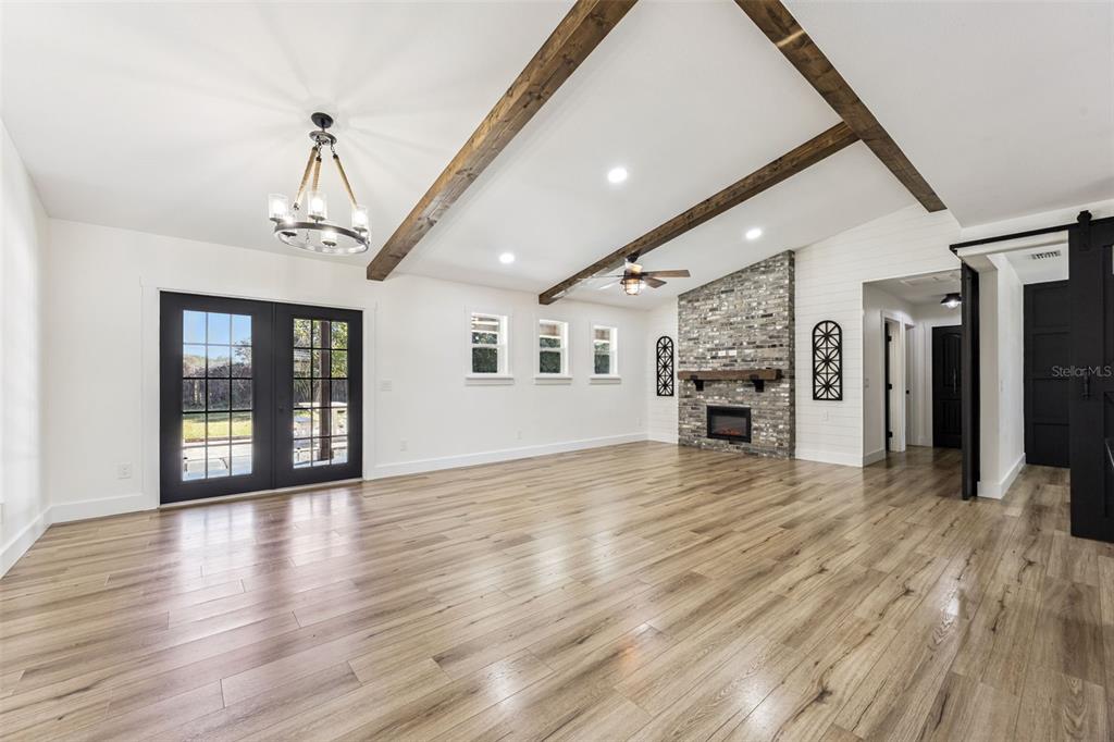 323 McLain Lane Geneva, FL 32732 - Photo 18 of 70 a view of livingroom with hardwood floor and a kitchen