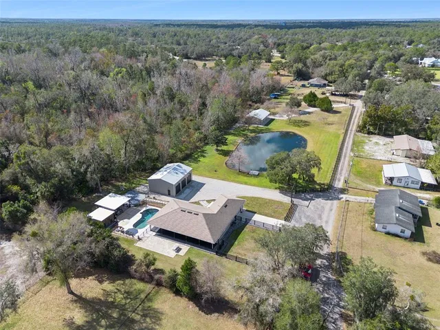 an aerial view of a house with outdoor space