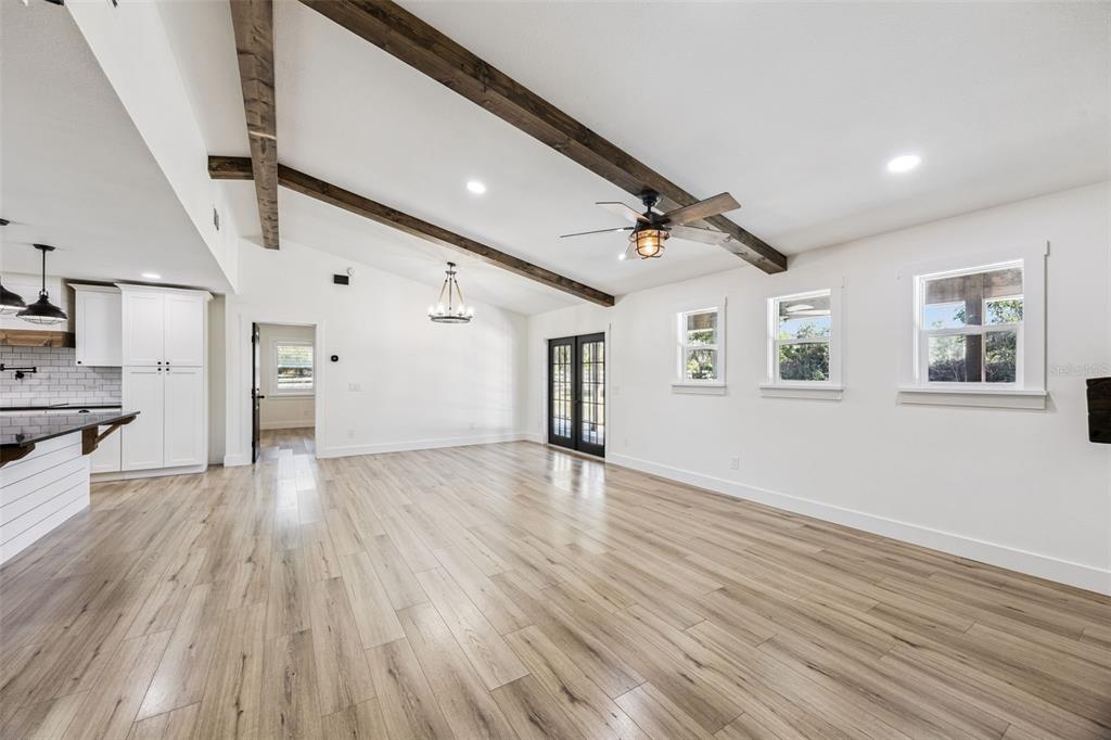 323 McLain Lane Geneva, FL 32732 - Photo 21 of 70 a view of empty room with wooden floor and windows