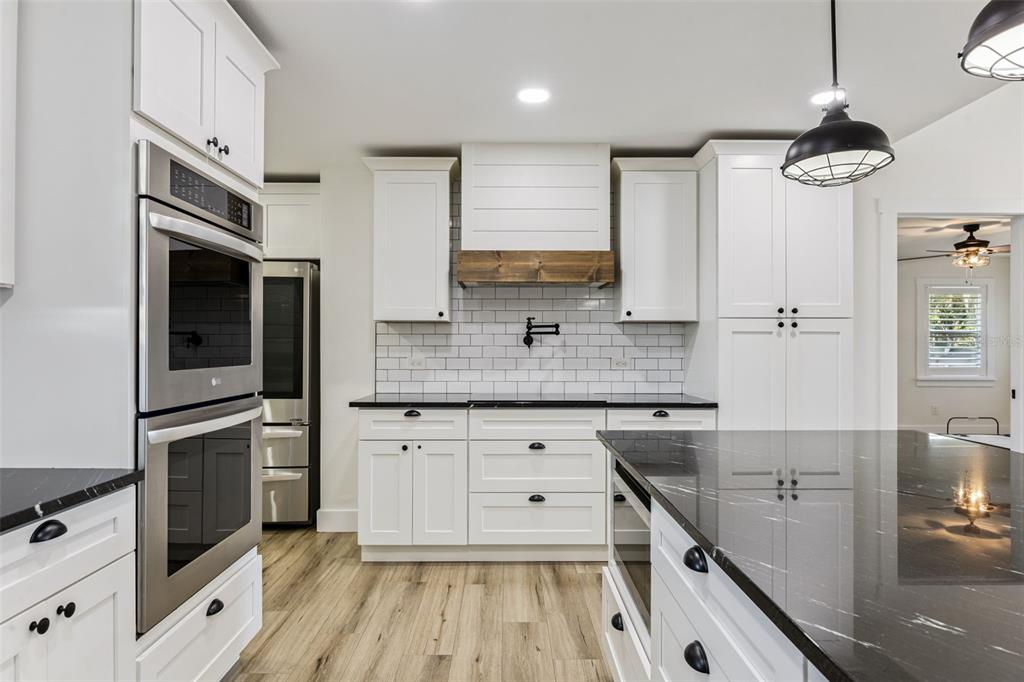 323 McLain Lane Geneva, FL 32732 - Photo 22 of 70 a kitchen with stainless steel appliances granite countertop a sink a stove and cabinets