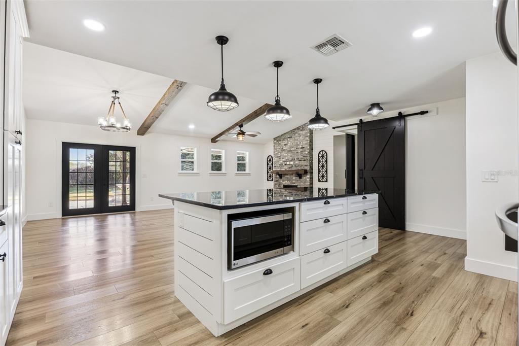 323 McLain Lane Geneva, FL 32732 - Photo 23 of 70 a kitchen with stainless steel appliances granite countertop a stove and a wooden floors