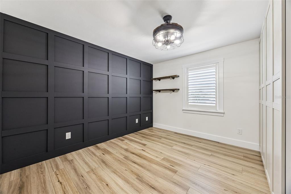 323 McLain Lane Geneva, FL 32732 - Photo 28 of 70 a bedroom with a bed and a chandelier