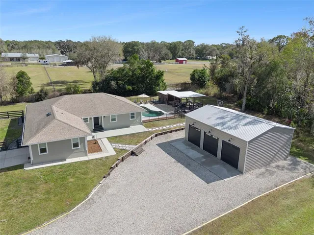 an aerial view of a house with a big yard