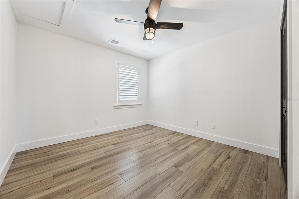 323 McLain Lane Geneva, FL 32732 - Photo 43 of 70 an empty room with wooden floor ceiling fan and window