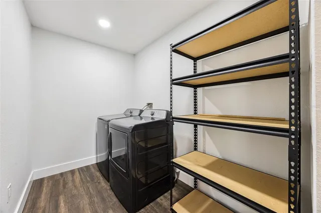 a view of a swimming pool with a yard and plants