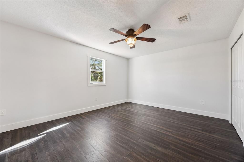 323 McLain Lane Geneva, FL 32732 - Photo 49 of 70 a view of empty room with wooden floor