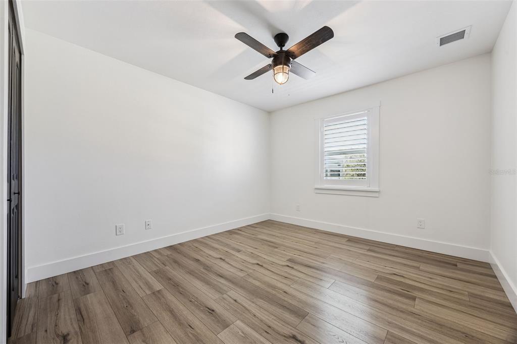 323 McLain Lane Geneva, FL 32732 - Photo 50 of 70 an empty room with wooden floor and windows