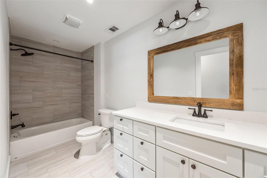 323 McLain Lane Geneva, FL 32732 - Photo 55 of 70 a bathroom with a toilet sink double vanity and bathtub