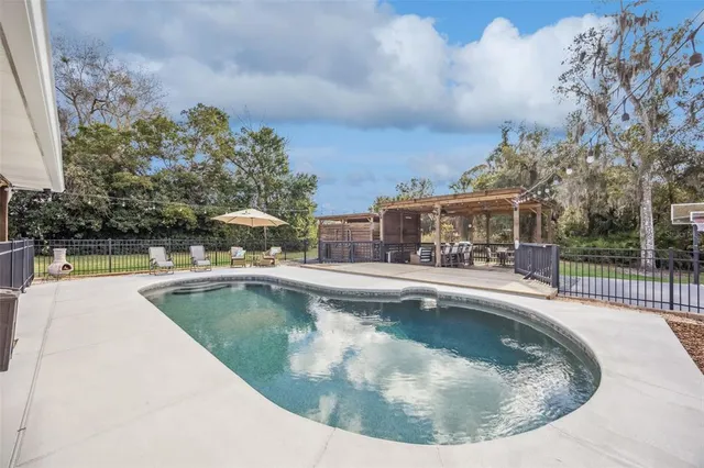 a view of a patio with table and chairs and wooden floor
