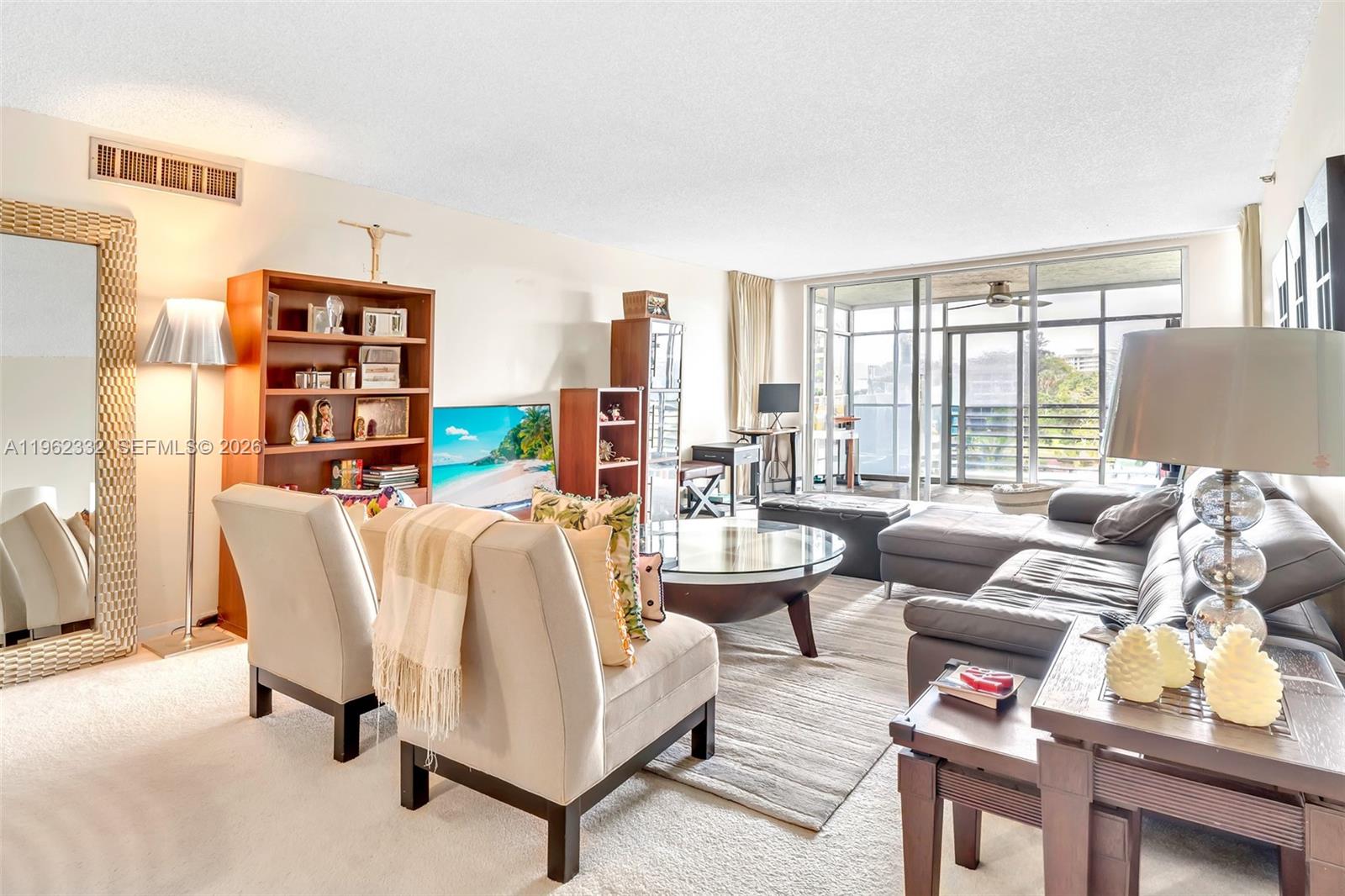 3510 Oaks Way, Unit 408 Pompano Beach, FL 33069 - Photo 13 of 27 a living room with furniture and a floor to ceiling window