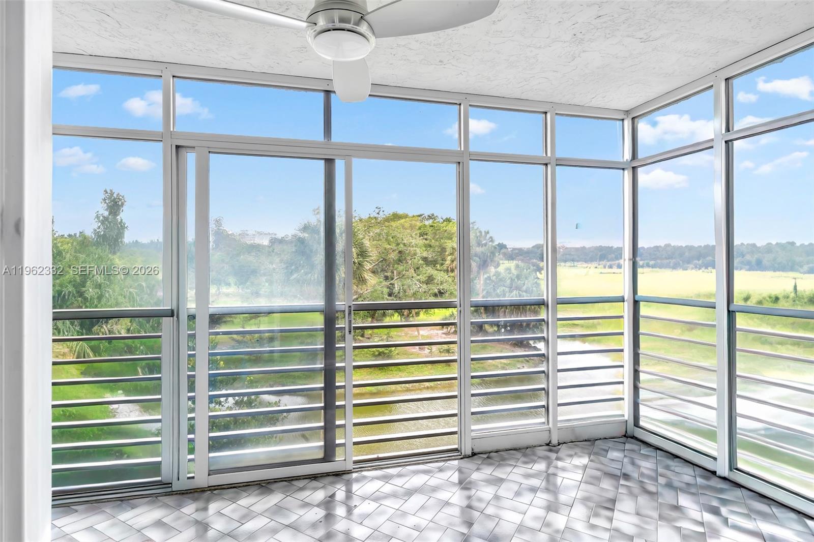 3510 Oaks Way, Unit 408 Pompano Beach, FL 33069 - Photo 16 of 27 a view of a room with window and a ceiling fan