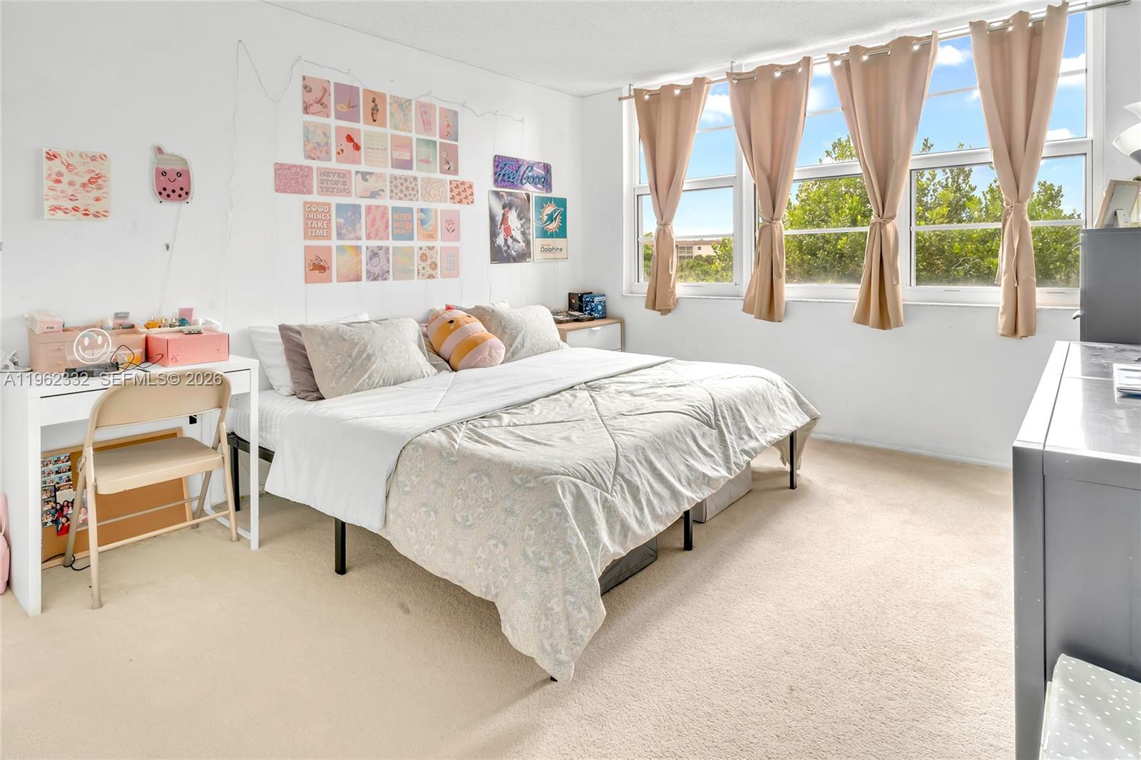 3510 Oaks Way, Unit 408 Pompano Beach, FL 33069 - Photo 17 of 27 a bedroom with a bed and a large window