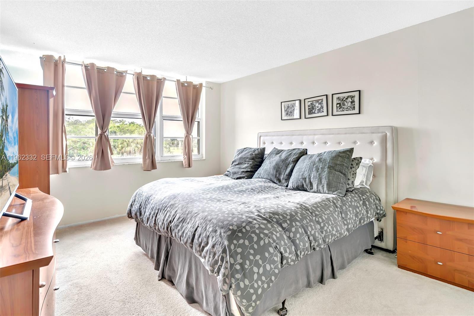 3510 Oaks Way, Unit 408 Pompano Beach, FL 33069 - Photo 20 of 27 a bedroom with a bed and a night stand