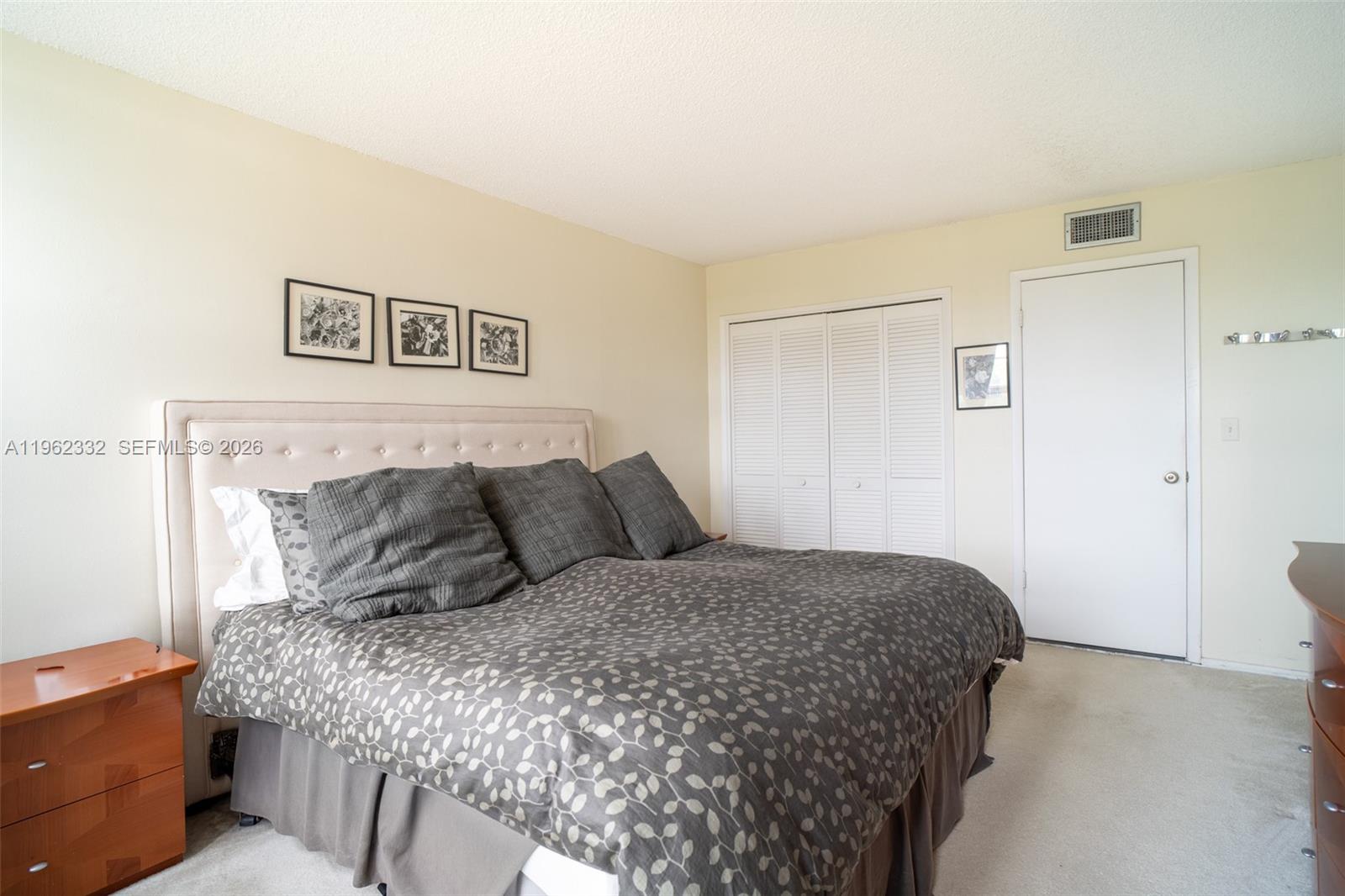 3510 Oaks Way, Unit 408 Pompano Beach, FL 33069 - Photo 21 of 27 a bedroom with a bed and a night stand