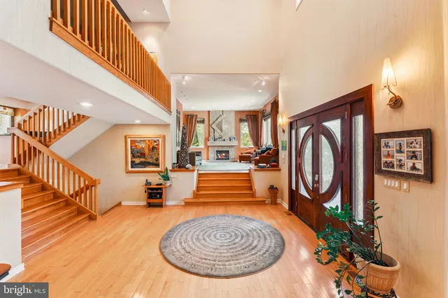 a dining hall with stainless steel appliances granite countertop a table chairs and a view of living room
