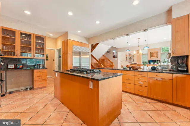 a bathroom with a shower sink vanity mirror and toilet