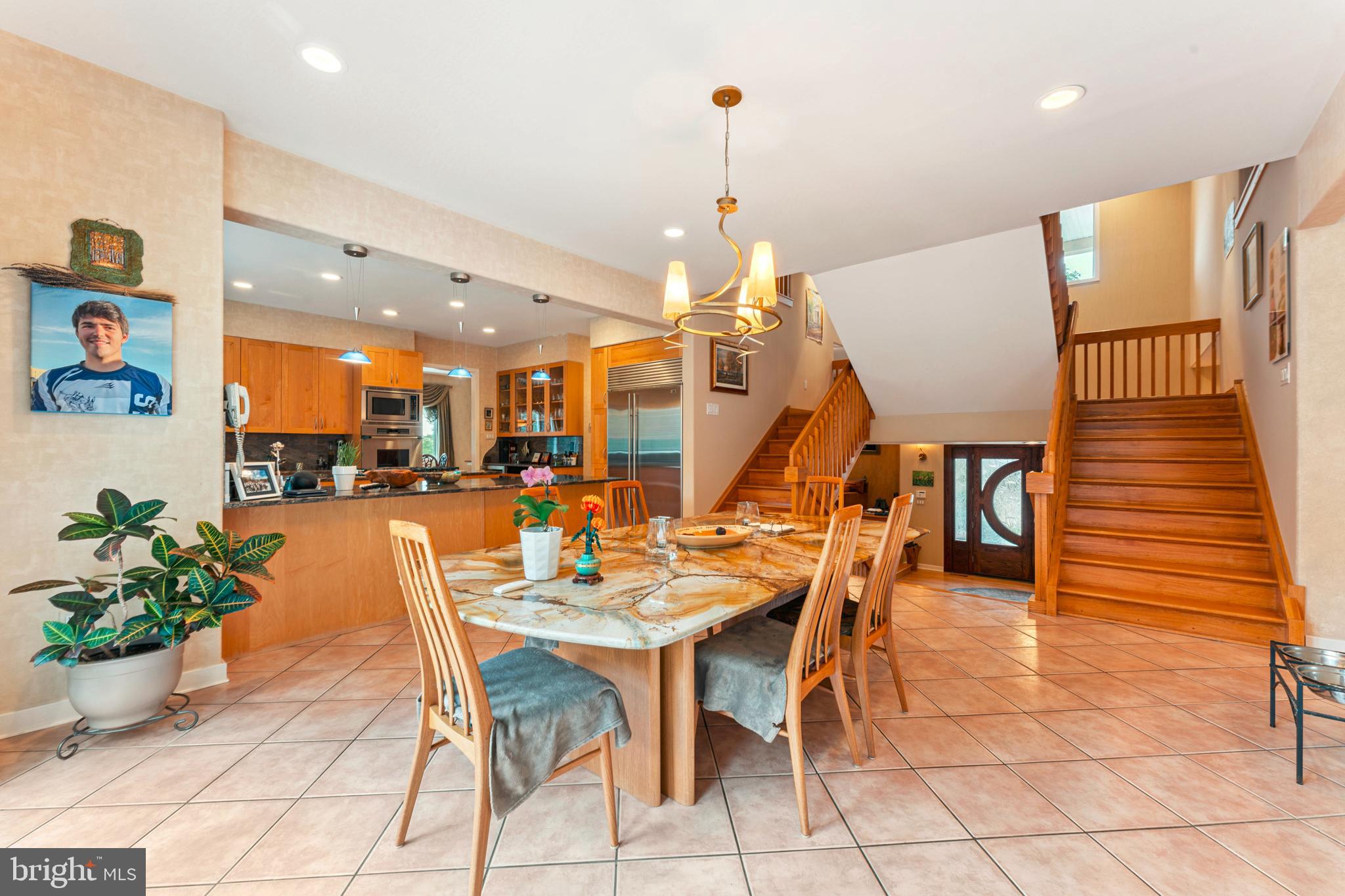1427 Byberry Road Huntingdon Valley, PA 19006 - Photo 21 of 46 a view of a dining room and livingroom with furniture wooden floor and a chandelier