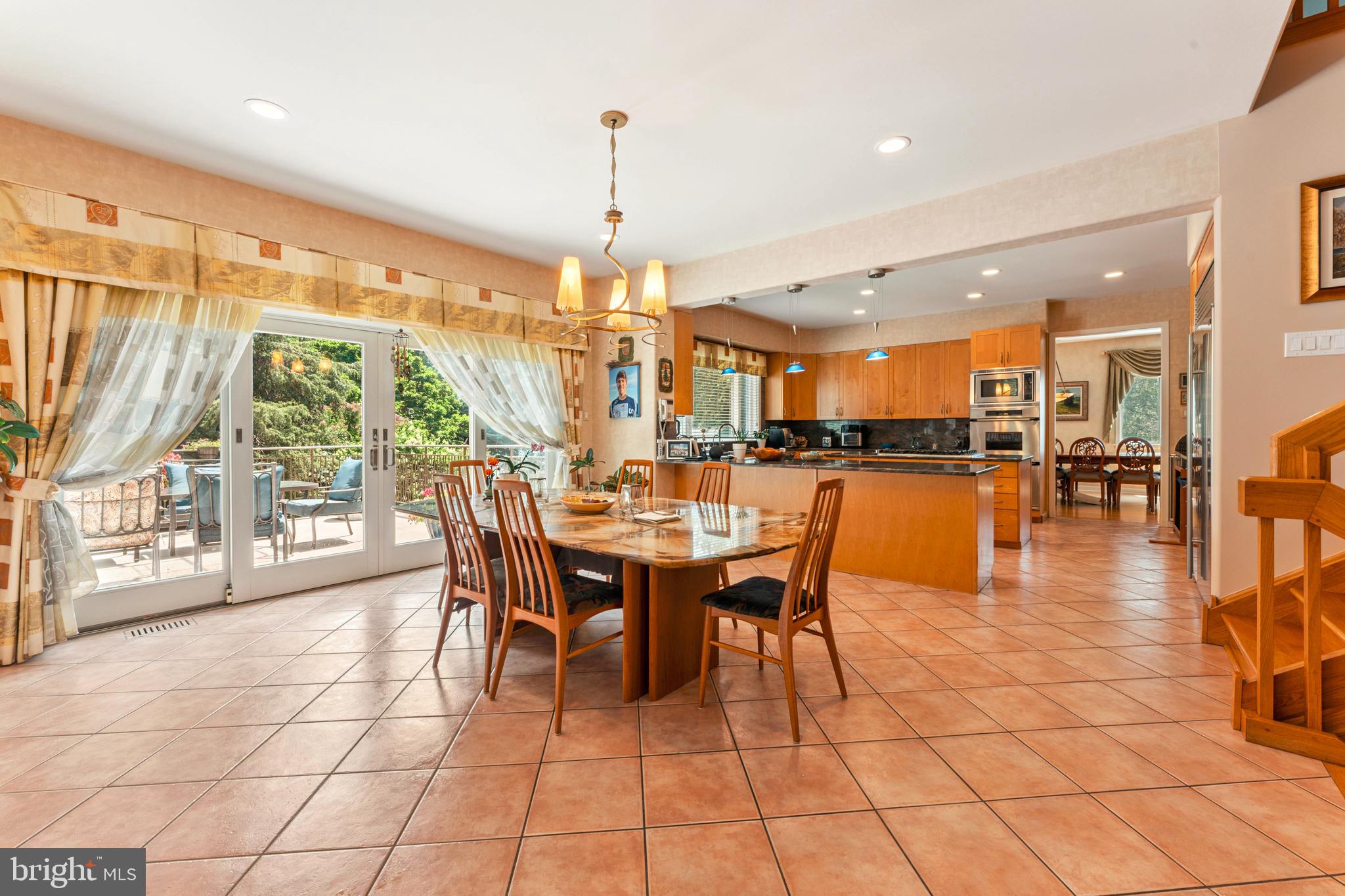 1427 Byberry Road Huntingdon Valley, PA 19006 - Photo 22 of 46 a dining hall with stainless steel appliances granite countertop a table chairs and a view of living room