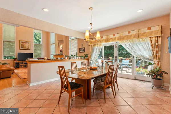 a dining room with furniture a chandelier and a rug