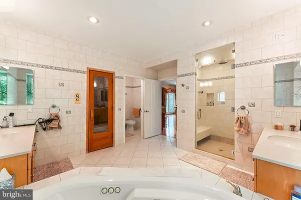 a spacious bathroom with a tub and shower