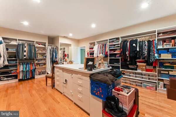 a kitchen with stainless steel appliances kitchen island granite countertop a refrigerator and wooden cabinets