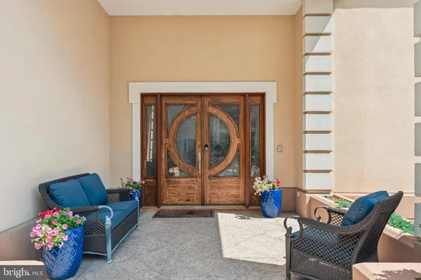 a living room with furniture and flowers