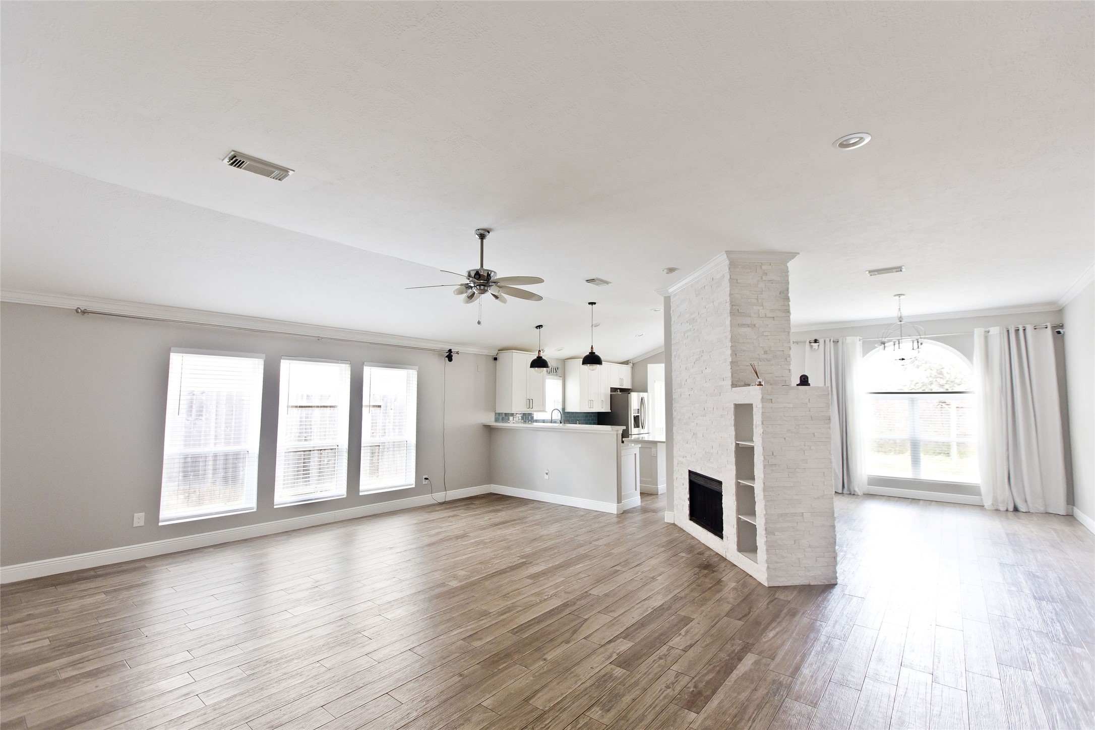 5807 Walkabout Way Katy, TX 77450 - Photo 11 of 25 a large white kitchen with large windows and refrigerator