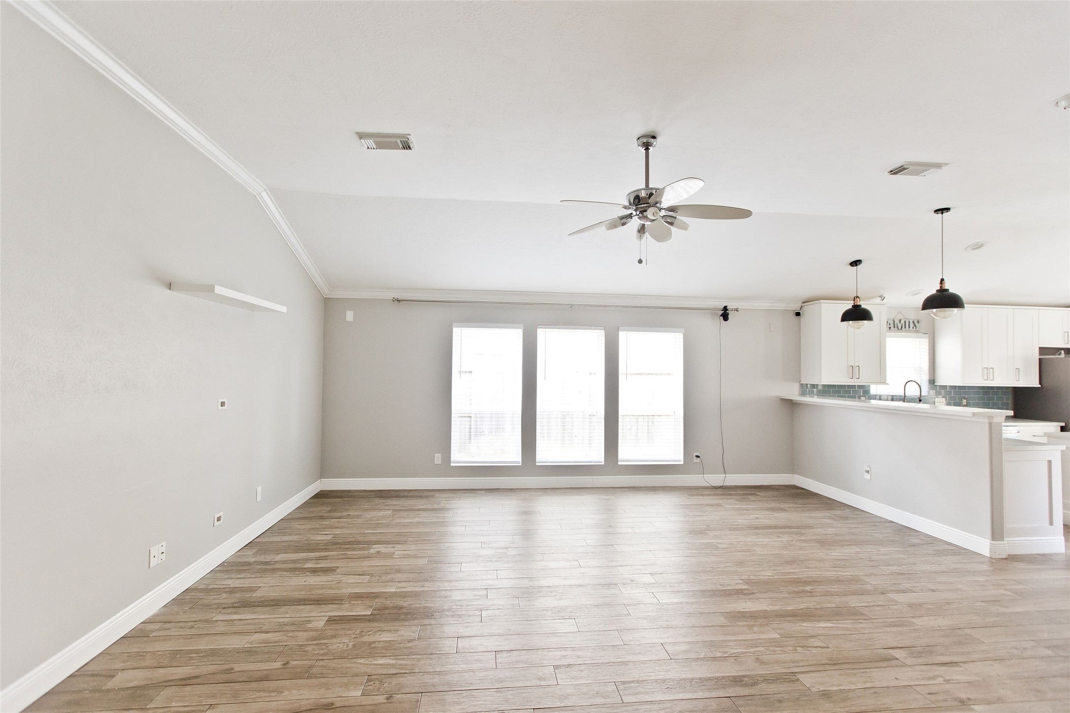 5807 Walkabout Way Katy, TX 77450 - Photo 12 of 25 a view of a kitchen with wooden floor and a ceiling fan