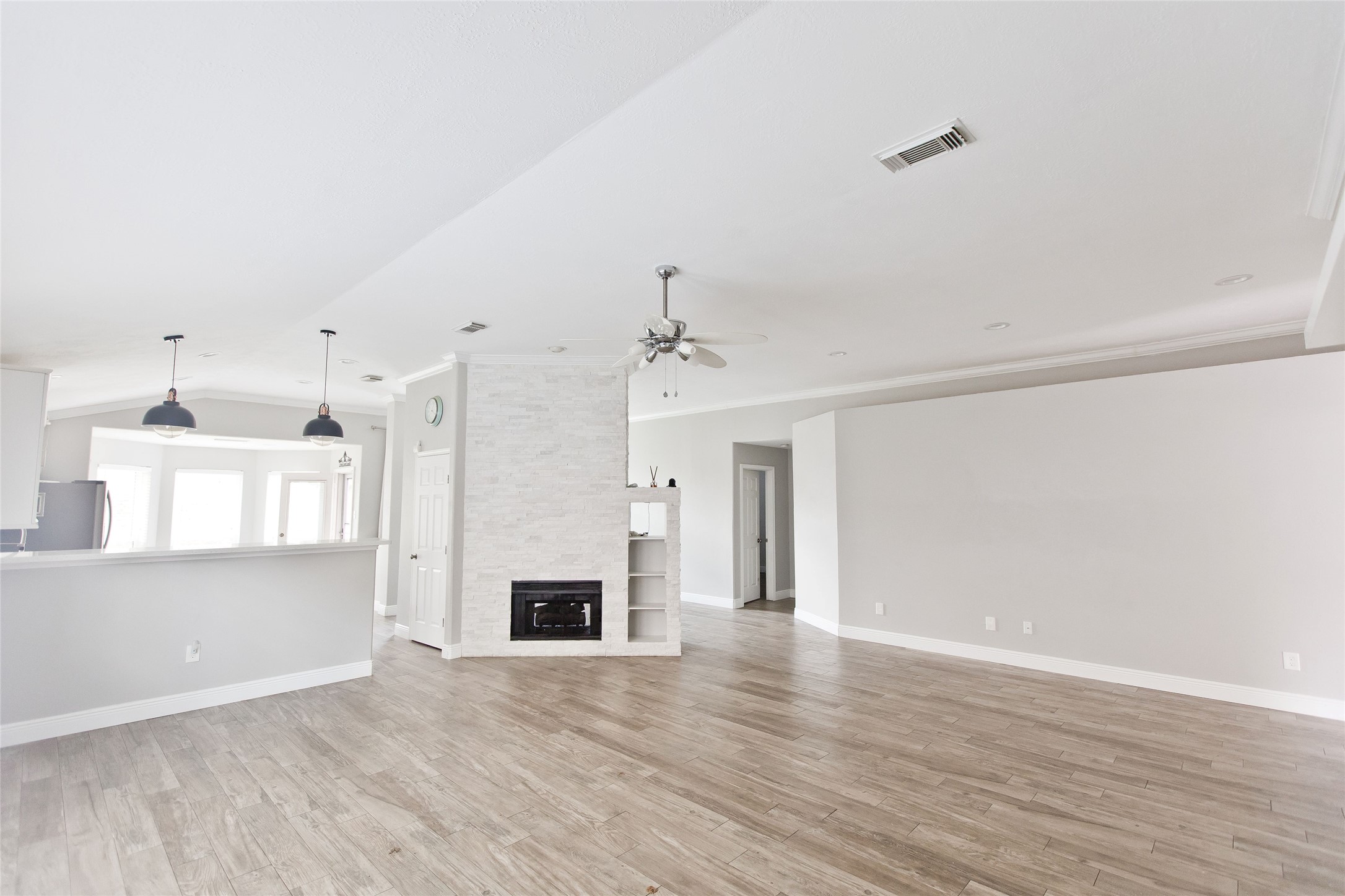 5807 Walkabout Way Katy, TX 77450 - Photo 14 of 25 a view of a livingroom with wooden floor and a kitchen