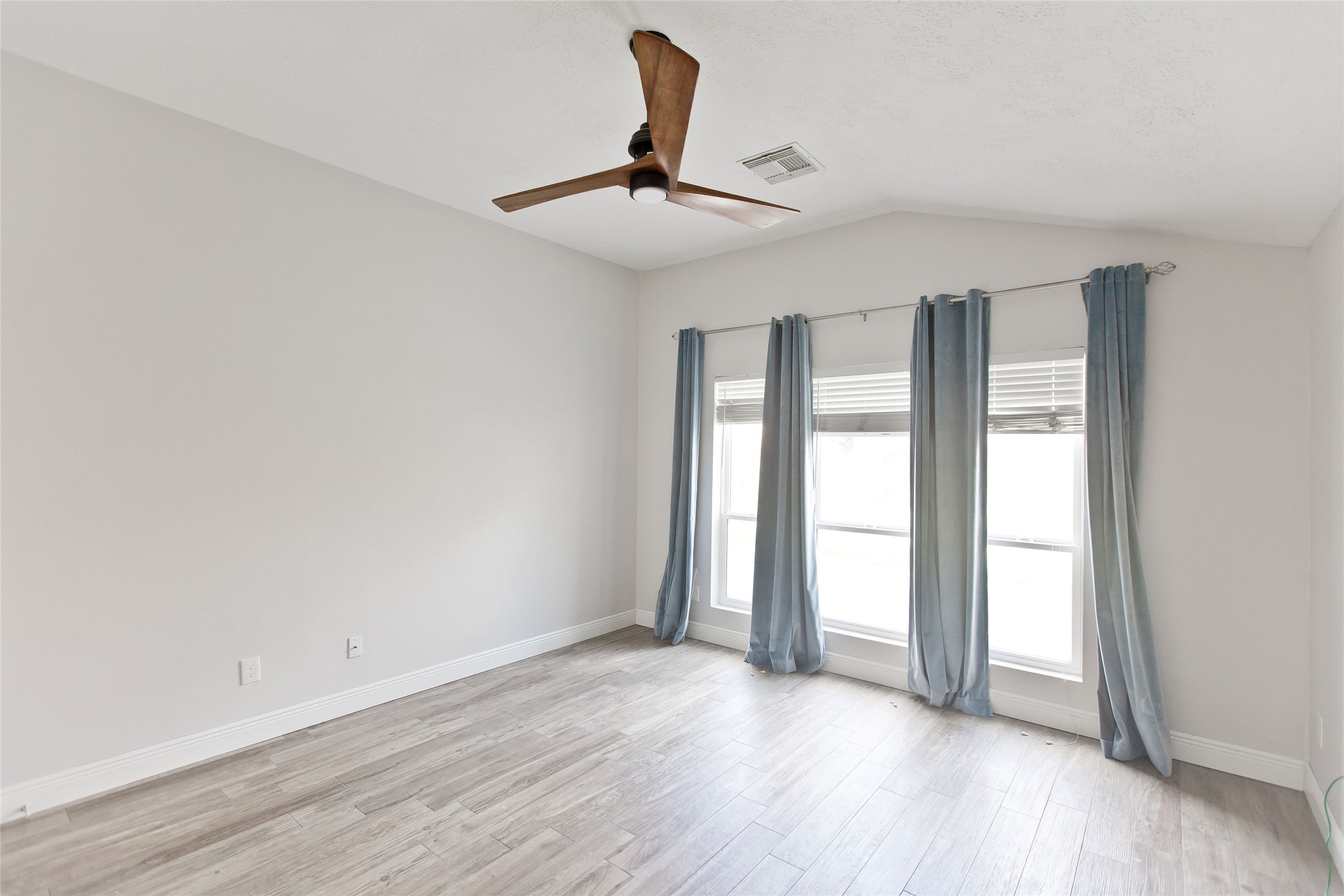 5807 Walkabout Way Katy, TX 77450 - Photo 20 of 25 a view of an empty room with wooden floor and a window