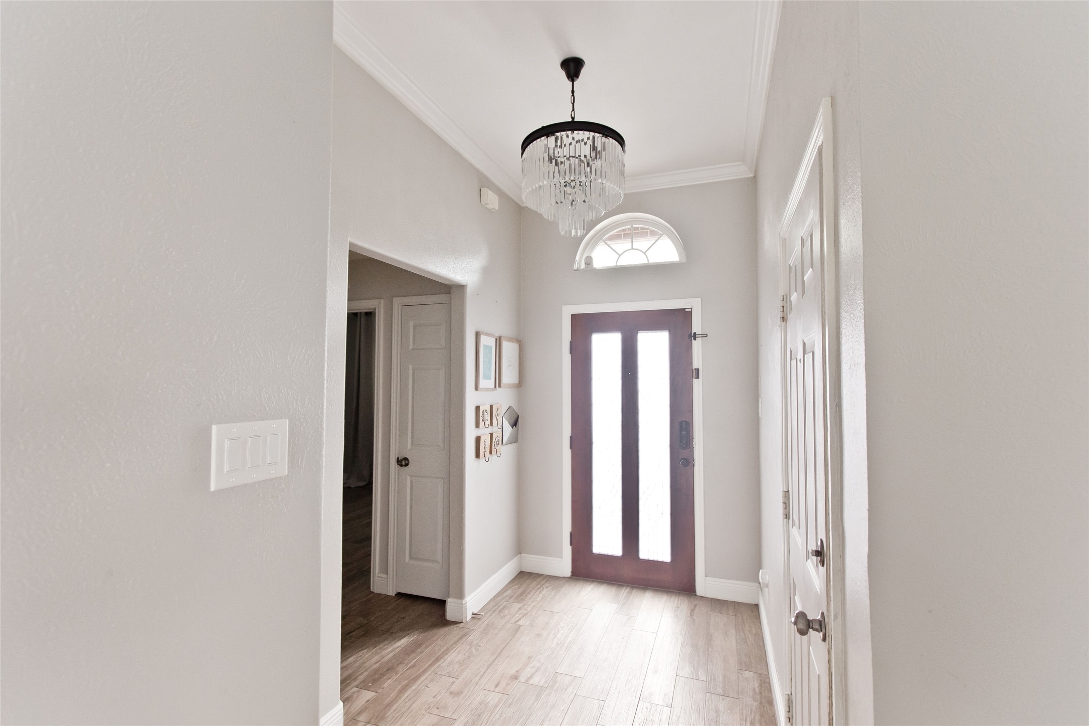 5807 Walkabout Way Katy, TX 77450 - Photo 2 of 25 an empty room with wooden floor and mirror