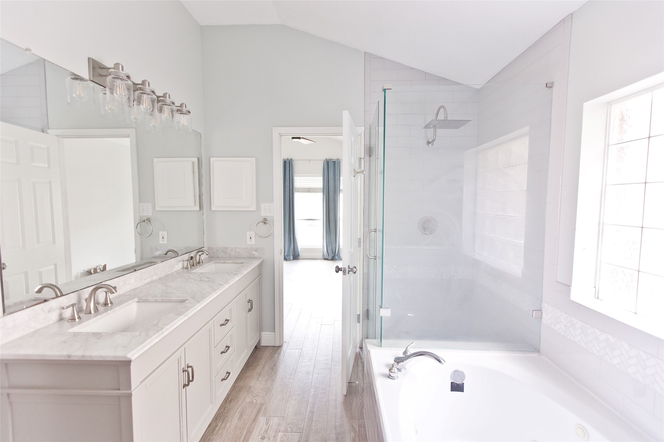 5807 Walkabout Way Katy, TX 77450 - Photo 21 of 25 a bathroom with a tub sink shower and a mirror