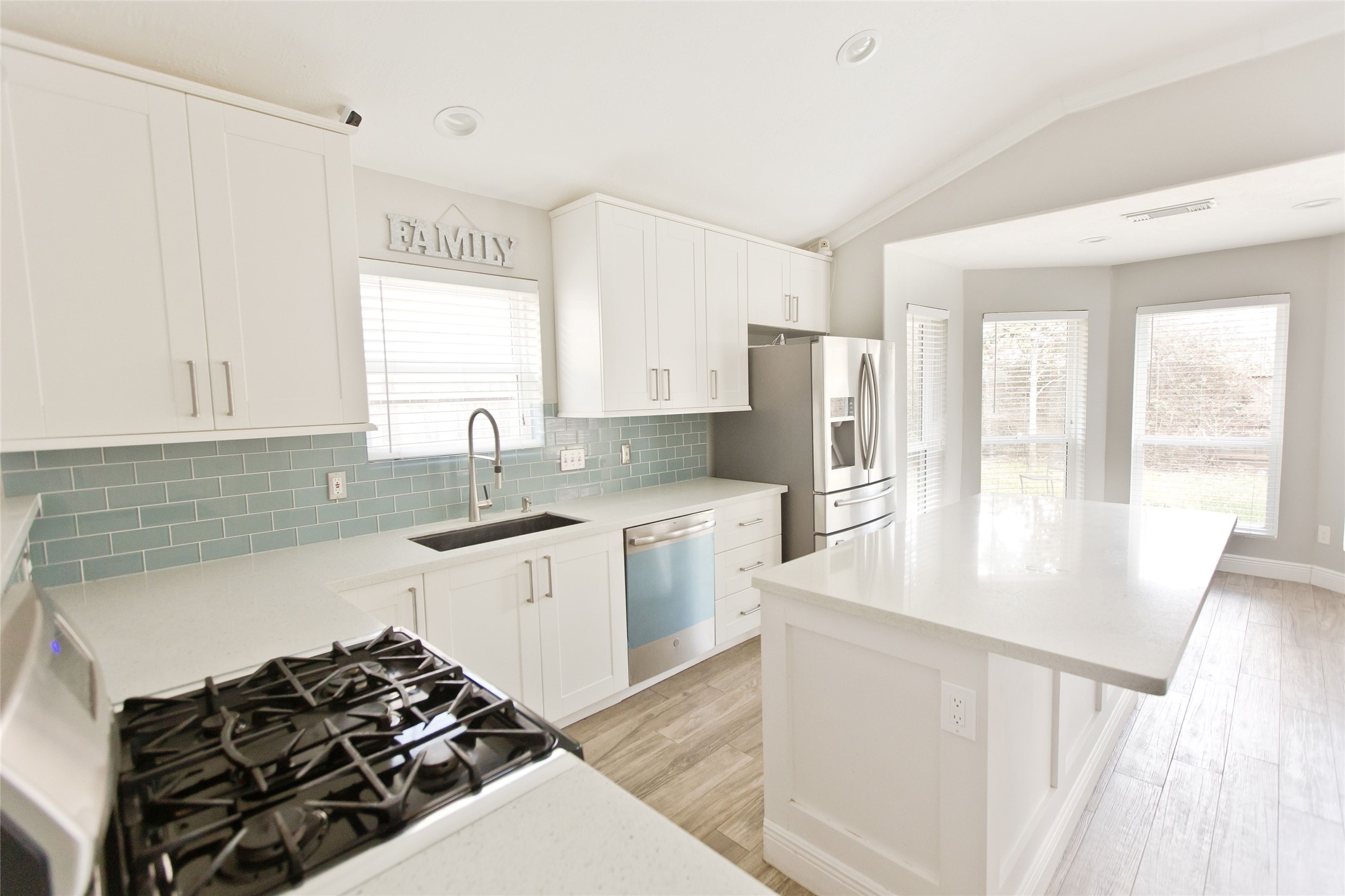 5807 Walkabout Way Katy, TX 77450 - Photo 3 of 25 a kitchen with a stove a sink and a refrigerator