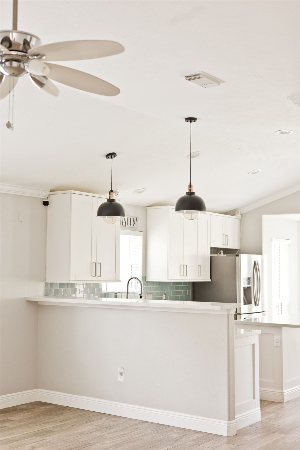 5807 Walkabout Way Katy, TX 77450 - Photo 4 of 25 a kitchen with kitchen island white cabinets and stainless steel appliances