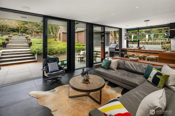 a living room with furniture and a floor to ceiling window