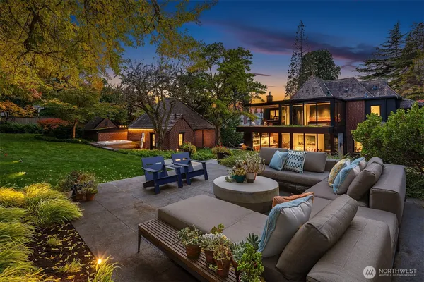 a view of a patio with couches table and chairs and potted plants