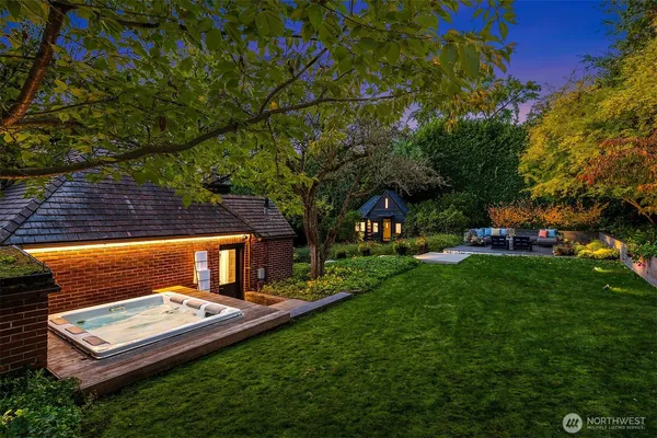 a backyard of a house with table and chairs