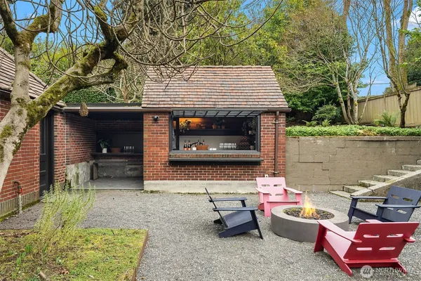 a backyard of a house with outdoor seating